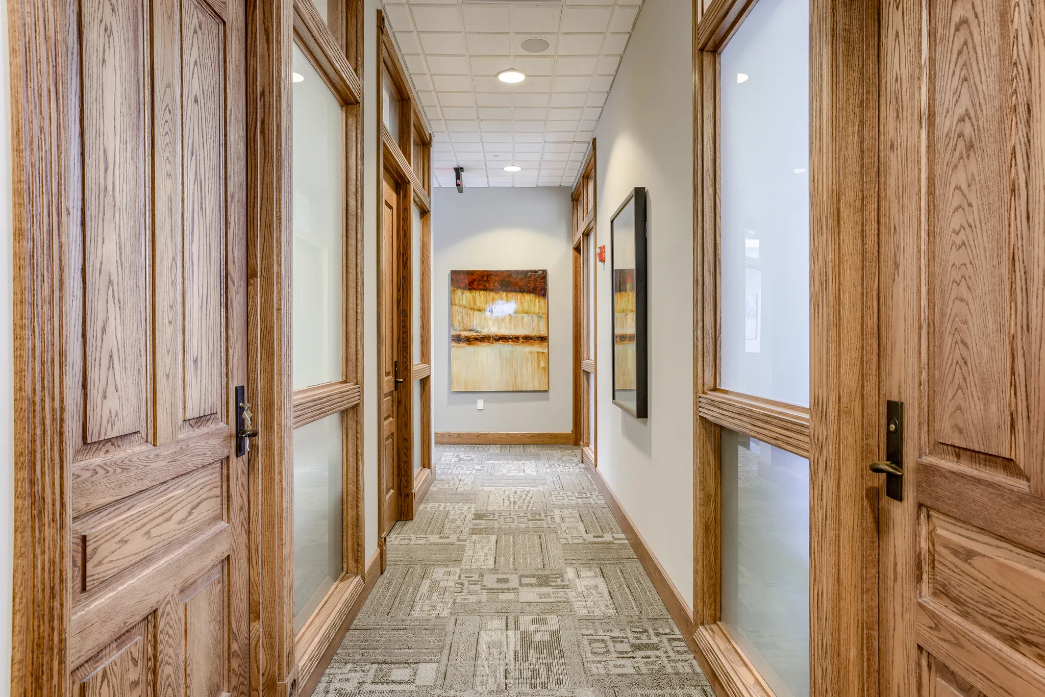 Wood-paneled corridor between Class A office suites at Millennium Plaza, West Omaha